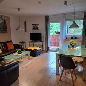 a living room with a couch and a table at Fewo-Hengesbach in Much +18 photos