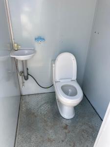 a bathroom with a toilet and a sink at КамбарАта in Tossor