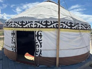 a yurt with a white and brown canopy at КамбарАта in Tossor