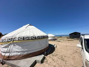 a boat in a tent on the beach at КамбарАта in Tossor