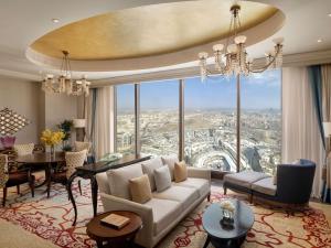 a living room with a couch and a large window at Makkah Clock Royal Tower, A Fairmont Hotel in Mecca