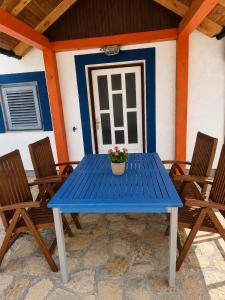 a blue table with a potted plant on a patio at Holiday home Moni in Karlobag
