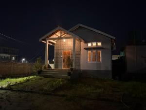 a small house lit up at night at Arkan Villa in Guwahati