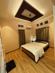 a bedroom with a large bed in a room at Arkan Villa in Guwahati