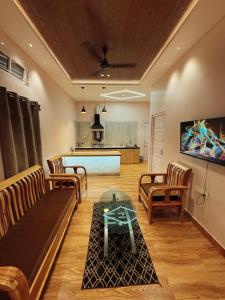 a living room with a couch and a table at Arkan Villa in Guwahati