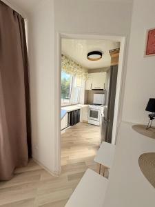 a room with a hallway with a kitchen and a room with at Kerese tn Apartment 1-2 persons in Narva