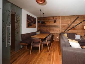 a dining room with a table and a couch at Kitzbühel alpine lodge with sauna in Mittersill +48 photos