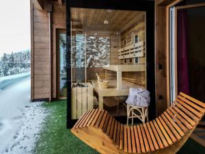a wooden house with a bench and a table at Kitzbühel alpine lodge with sauna in Mittersill