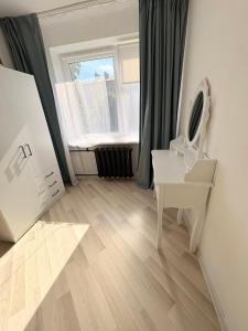 a white bathroom with a sink and a mirror at Kerese tn Apartment 1-2 persons in Narva