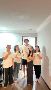 a group of people standing in a room at No Plans No Complaints Backpackers Hostel in Ayer Itam