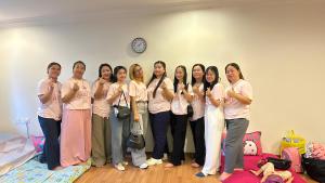 a group of women standing in a room at No Plans No Complaints Backpackers Hostel in Ayer Itam