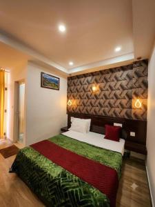 a bedroom with a large bed in a room at Parudeesa Pool Resort in Vattavada