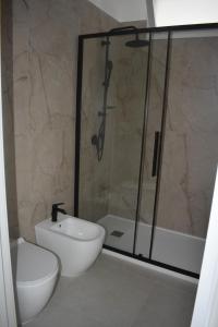 a bathroom with a shower and a toilet and a sink at Terrazza sul Borgo in Polignano a Mare