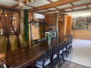 a large wooden table in a room with chairs at Тихият кът in Sapareva Banya