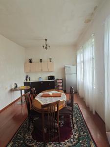 a dining room with a table and chairs and a kitchen at House Dea Dea in Chakvi