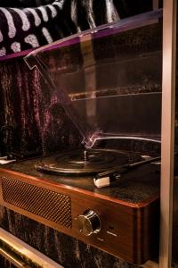 a toaster oven with a vinyl record on it at Urban Budget Hotel- Unique Boutique Hotel on Best Location in Vienna +83 photos