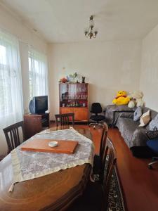 a living room with a table and a couch at House Dea Dea in Chakvi