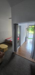 a room with two beds and a room with a window at D&ATurism in Prăjila