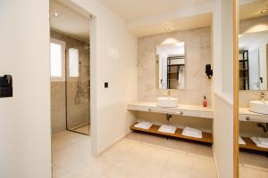 a bathroom with two sinks and a shower at Olympion Village in Kavos +57 photos