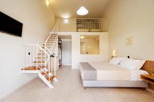 a bedroom with a bed and a spiral staircase at Olympion Village in Kavos