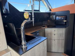 a kitchen with a sink and a faucet at The North Bank in Poole