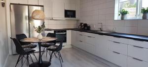 a kitchen with a table and chairs in a kitchen at Apartment Sollid - Your comfortable accommodation in Huskvarna