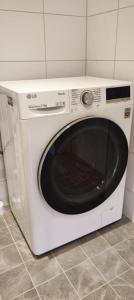 a white microwave oven sitting in a kitchen at Apartment Sollid - Your comfortable accommodation in Huskvarna