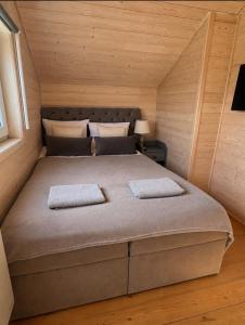 a bedroom with a large bed in a small room at Silver Park Resort 10m do plaży in Gąski