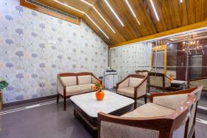 a dining room with chairs and a table and a table and chairsktop at Hotel Leela Grande in Karnāl