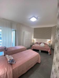 a hotel room with two beds and a window at ALBATROS Suites&Rooms in Naples +138 photos