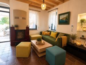 a living room with a green couch and a fireplace at Aeolian Garden in Mytilene