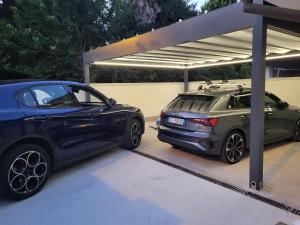 two cars parked next to each other in a garage at Domus Mirea in Aquiléia