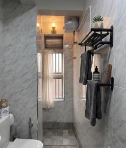 a bathroom with a shower and a toilet and a window at Rift Valley in Bulenga