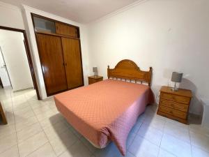 a bedroom with a bed and a dresser and a door at Casa Canoa B in Armação de Pêra +9 photos