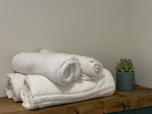 a pile of towels sitting on top of a wooden shelf at Apartment 299 - Clifden in Clifden +16 photos