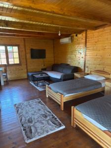 a living room with two beds and a couch at Laki House Skadar lake in Železnička Stanica Zeta