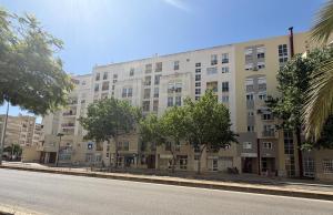 a large apartment building on a city street at Casa Canoa B in Armação de Pêra