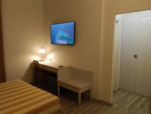a room with a desk with a lamp and a bed at Camere LAURO ROSSI in Macerata