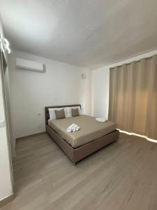 a bedroom with a bed in the middle of a room at Domus Smeralda in Muravera