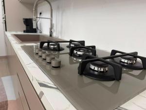 a kitchen counter with four burners on a stove at Domus Smeralda in Muravera