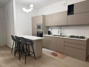 a kitchen with a counter and some stools in it at Domus Smeralda in Muravera