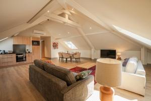 a living room with a couch and a table at La Chapelle in Annecy