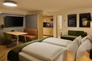 a hotel room with a bed and a table at Cinema City Hotel Europaplatz Karlsruhe - Brand New Boutique Hotel 2025 - in Karlsruhe