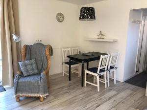 a dining room with a table and a chair at FEWO Turf Watt Nr.5 in Cuxhaven