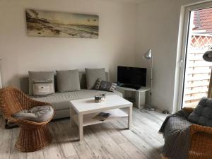 a living room with a couch and a table at FEWO Turf Watt Nr.5 in Cuxhaven