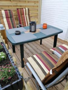 a blue table on a patio with two chairs at FEWO Turf Watt Nr.5 in Cuxhaven +12 photos