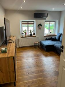 a living room with a couch and a tv at Green House Giławy in Giławy
