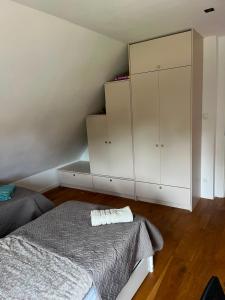 a bedroom with a bed and a cabinet at Green House Giławy in Giławy