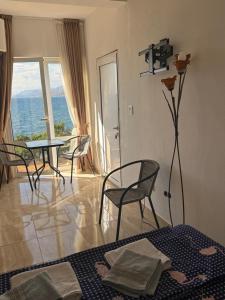 a room with a bed and chairs and a table at Apartments Stuart in Utjeha