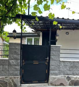 a black door on the side of a house at Kostas guest house in Borjomi